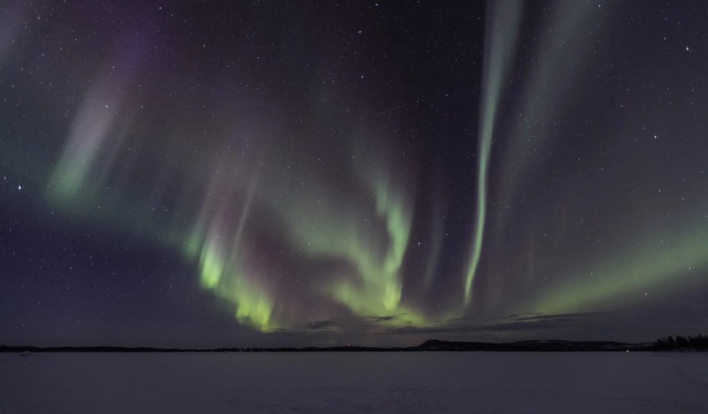 Northern lights over a frozen lake.