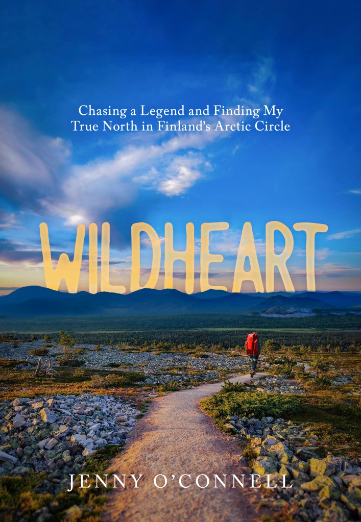 WILDHEART book cover with Jenny walking toward blue mountains while wearing a red backpack.